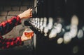 Woman`s hand holds a glass and pours light craft beer from the tap Royalty Free Stock Photo
