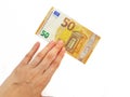 The woman`s hand holds the paper money of the euro against a white background. Greed. Debts. Salary. Credit. Royalty Free Stock Photo