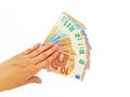 The woman`s hand holds the paper money of the euro against a white background. Royalty Free Stock Photo