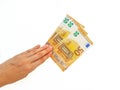 The woman`s hand holds the paper money of the euro against a white background. Royalty Free Stock Photo