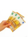 The woman`s hand holds the paper money of the euro against a white background. Royalty Free Stock Photo