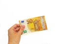 The woman`s hand holds the paper money of the euro against a white background. Royalty Free Stock Photo