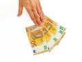 The woman`s hand holds the paper money of the euro against a white background. Royalty Free Stock Photo