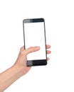 A woman`s hand holds a phone with a white screen on a white background, isolate. Empty smartphone display with space for text Royalty Free Stock Photo