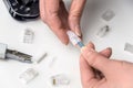 A woman's hand inserts an internet cable into a clamp connector. utp ethernet network cable plug. The concept of internet Royalty Free Stock Photo