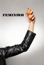 A woman`s hand in a leather jacket, holding chicken eggs. Feminism, girl power, and the concept of equal rights and independence