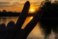 Woman`s hand making peace sign at sunset Royalty Free Stock Photo