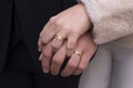 A woman`s hand on a man`s hand with rings. Royalty Free Stock Photo