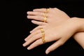 Woman`s hand with many different gold rings