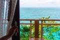 Woman`s hand opening a glass door of hotel room to the ocean view balcony Royalty Free Stock Photo