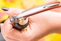 A woman`s hand opens a bottle of white wine with a corkscrew.. Top view. Royalty Free Stock Photo