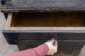 a woman& x27;s hand opens a drawer of an old chest of drawers Royalty Free Stock Photo