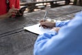 Woman's hand with pen completing application form