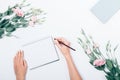 Woman's hand with pencil making notes on blank sheet Royalty Free Stock Photo