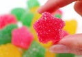 Woman`s Hand Picking Vibrant Hot Pink Sugar Coated Fruity Flavored Soft Jelly Candy Royalty Free Stock Photo