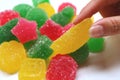 Woman`s Hand Picking Vivid Yellow Fruity Sugar Coated Jelly Soft Candies Royalty Free Stock Photo