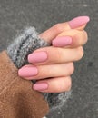 Woman`s hand with pink manicure