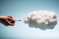 Woman`s hand plugging a wire into a white cloud.