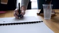 A woman's hand pointing and underlining in the papers about a new project in the office.