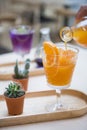 Woman's hand pouring orange juice into a glass Royalty Free Stock Photo