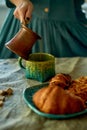 A woman`s hand pours coffee brewed in Turk.Rustic simplicity.