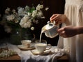 woman\'s hand pours milk into the cup