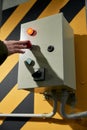 A woman\'s hand presses the button to open the roller shutter doors at an industrial enterprise Royalty Free Stock Photo