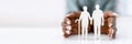 Woman's Hand Protecting Senior Couple Cutout Figures Over White