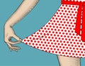 Woman`s hand pull the edge of the polka-dot dres