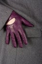 Woman`s hand in purple leather glove and grey woolen coat Royalty Free Stock Photo