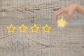 Woman's hand put the stars to complete five stars. Customer satisfaction concept. copy space Royalty Free Stock Photo