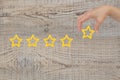 Woman's hand put the stars to complete five stars. Customer satisfaction concept. copy space Royalty Free Stock Photo