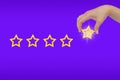 Woman\'s hand put the stars to complete five stars. giving a five star rating. Service rating, satisfaction concept Royalty Free Stock Photo