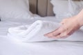 woman's hand puts a clean white terry towel on the bed Royalty Free Stock Photo