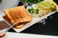 Woman`s hand puts freshly baked toast on a plate Royalty Free Stock Photo