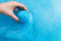 Woman`s hand putting bath bomb into water Royalty Free Stock Photo