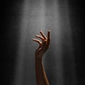 Woman's hand reaches for the light rays Royalty Free Stock Photo