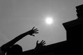 Woman`s hand reaching for the sun with silhouette of modern buil Royalty Free Stock Photo