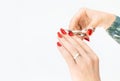 Woman's hand with red manicure cutting nails with scissors Royalty Free Stock Photo