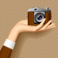 Woman`s hand with retro photo camera Royalty Free Stock Photo