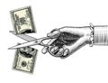 Woman`s hand with scissors cutting a 100 dollar banknote