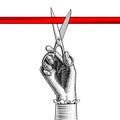 Woman`s hand with scissors cutting red ribbon Royalty Free Stock Photo
