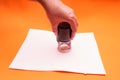 Woman`s hand with the seal, stamp. Process stamping the contract, documents, close up.