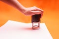 Woman`s hand with the seal, stamp. Process stamping the contract, documents, close up.