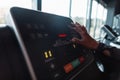 Woman\'s hand selects the mode on the treadmill in the gym, close-up