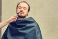 A woman`s hand shaves a man`s beard with a safety razor, copy spce Royalty Free Stock Photo