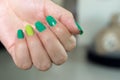 Woman`s hand showing her painted fingernails with drops of water