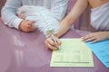 Groom and bride register marriage. Woman puts his signature on wedding . A woman`s hand signs and registers his marriage with the Royalty Free Stock Photo