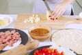 Woman`s hand slicing pile of cheese