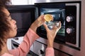 Woman`s Hand Squeezing Halved Lemon In Bowl Royalty Free Stock Photo